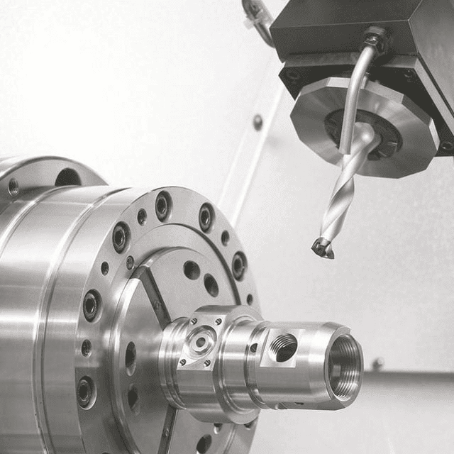 CNC machine drilling metal part with precision.